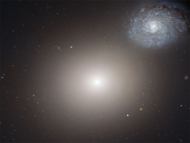 Hubble snapped this image of the elliptical galaxy Messier 60, center, and the spiral galaxy NGC 4647 (NASA / ESA / the Hubble Heritage / STScI / AURA / Hubble Collaboration)