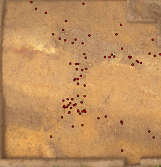A view of the Hermeskeil camp’s gateway with remains of the stone pavement. Red dots pinpoint sites where shoe nails from the sandals of Roman soldiers were found (© Sabine Hornung / Arno Braun)