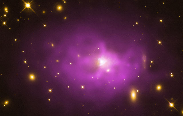 This image shows a large elliptical galaxy located about 1.3 billion light years away in one of the 18 galaxy clusters studied by the team - the galaxy cluster PKS 0745 (NASA / CXC / Stanford / STScI / NSF / NRAO / VLA / Hlavacek-Larrondo J. et al)