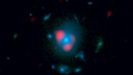 This image combines data from ALMA and Hubble. Shown in red is the distant, background galaxy, being distorted by the gravitational lens effect produced by the galaxy in the foreground, shown in blue as measured by Hubble. The background galaxy appears warped into a so-called Einstein ring: a circle of light around the foreground galaxy (Dan Marrone)