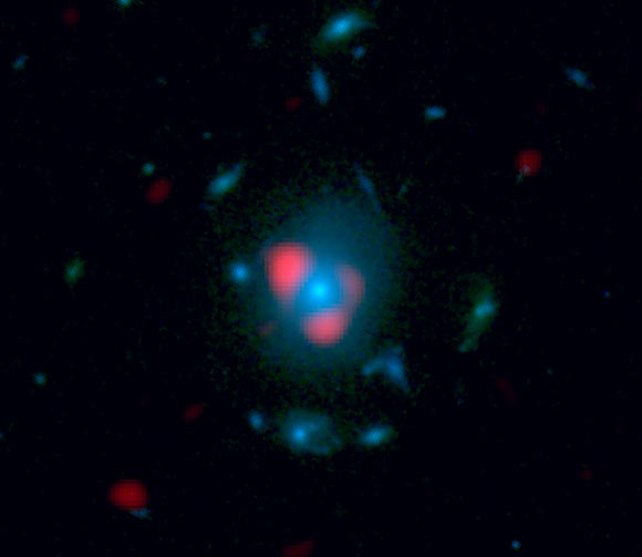 This image combines data from ALMA and Hubble. Shown in red is the distant, background galaxy, being distorted by the gravitational lens effect produced by the galaxy in the foreground, shown in blue as measured by Hubble. The background galaxy appears warped into a so-called Einstein ring: a circle of light around the foreground galaxy (Dan Marrone) This image combines data from ALMA and Hubble. Shown in red is the distant, background galaxy, being distorted by the gravitational lens effect produced by the galaxy in the foreground, shown in blue as measured by Hubble. The background galaxy appears warped into a so-called Einstein ring: a circle of light around the foreground galaxy (Dan Marrone)