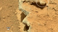 This image shows a rock outcrop called Hottah. Broken surfaces of the outcrop have rounded, gravel clasts, such as the one circled in white, which is about 1.2 inches across. Erosion of the outcrop results in gravel clasts that protrude from the outcrop and ultimately fall onto the ground, creating the gravel pile at left (NASA / JPL-Caltech / MSSS)