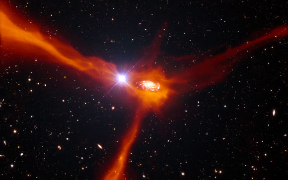This artist’s impression shows a galaxy in the distant Universe, just two billion years after the Big Bang, in the process of pulling in cool gas, shown in orange, from its surroundings (ESO / L. Calçada / ESA / AOES Medialab)