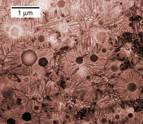 The round nodules are the q-glass, not crystalline but with a well-defined chemical composition (Leonid A. Bendersky / NIST)