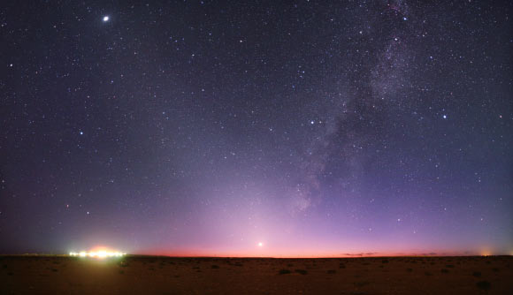 Zodiacal light scattered from dust grains in our Solar System is seen rising diagonally up to the left in this image, as the plane of the Milky Way rises up to the right (Tunc Tezel / TWAN / APOD).