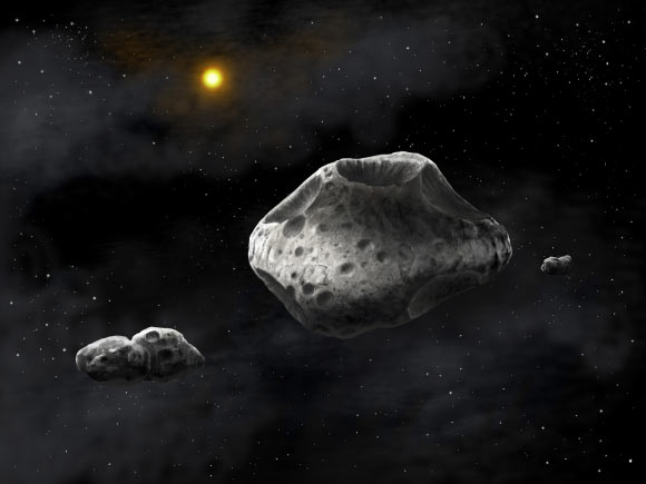 This is an artist's impression of the triple asteroid system Sylvia. The two moons, Romulus and Remus, are shown to be strongly elongated, and composed of two lobes. Image credit: Danielle Futselaar / SETI Institute.
