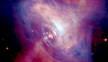 This composite image shows the Crab Nebula. The Crab pulsar is in the center of the image. Image credit: X-ray - NASA / CXC / ASU / J. Hester et al.; optical - NASA / HST / ASU / J. Hester et al.