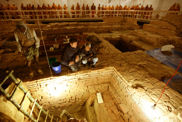 Prof Robin Coningham, left, and Dr Kosh Prasad Acharya direct excavations within the Maya Devi Temple, uncovering a series of ancient temples contemporary with the Buddha. Image credit: Ira Block / National Geographic.