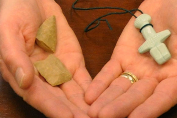 Dr Sally Stewart of the University of Toronto holds replicas of stone tools and decorative jewelry found at Ayia Varvara Asprokremnos. Image credit: Jessica Lewis.