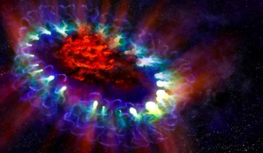 This is an artist's impression of the SN 1987A remnant. The image is based on real data and reveals the cold, inner regions of the remnant, in red, where tremendous amounts of dust were detected and imaged by ALMA. This inner region is contrasted with the outer shell, lacy white and blue circles, where the blast wave from the supernova is colliding with the envelope of gas ejected from the star prior to its powerful detonation. Image credit: ALMA / ESO / NAOJ / NRAO / Alexandra Angelich, NRAO / AUI / NSF.