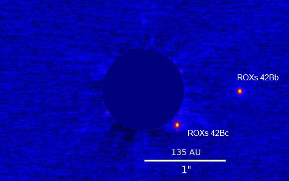This image, taken with the Keck telescope, shows the ROXs 42B system: ROXs 42Bb orbits at about 150 astronomical units; ROXs 42Bc is a candidate companion or an unrelated background star. Image credit: Thayne Currie et al.