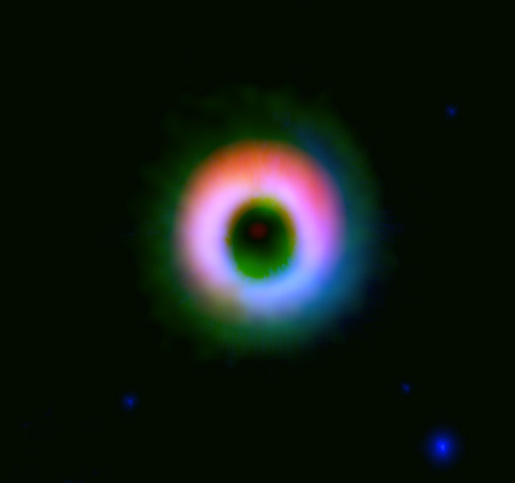 This image shows a dusty protoplanetary disk around HD142527. The dust and gas are shown in red and green, respectively; near-infrared image taken by the NAOJ Subaru Telescope is shown in blue. The image clearly shows that the dust is concentrated in the upper part of the disk. Image credit: ALMA / ESO / NAOJ / NRAO / Fukagawa et al.