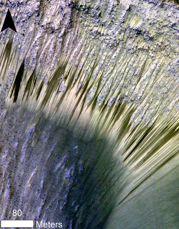 Recurring slope lineae observed in HiRISE images of Mars. The RSL form on Sun facing slopes during warm season and fade during cold season. Image credit: Lujendra Ojha et al / Geophysical Research Letters.