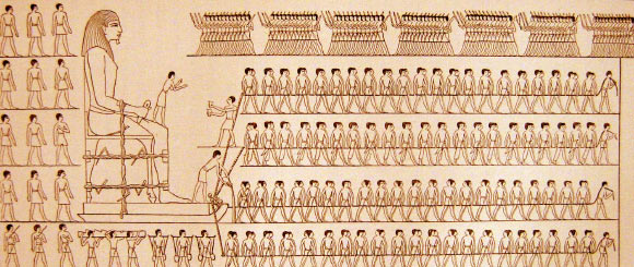 Drawing of a wall painting from the tomb of Djehutihotep, a semi-feudal ruler of an Ancient Egyptian province, 1880 BC. A person standing at the front of the sled is pouring water onto the sand.