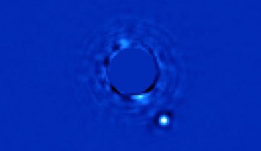 Gemini Planet Imager captured this first light image of Beta Pictoris b, a planet orbiting the star Beta Pictoris. The star, Beta Pictoris, is blocked in this image by a mask. Image credit: Lawrence Livermore National Laboratory.