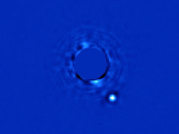 Gemini Planet Imager captured this first light image of Beta Pictoris b, a planet orbiting the star Beta Pictoris. The star, Beta Pictoris, is blocked in this image by a mask. Image credit: Lawrence Livermore National Laboratory.