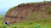 An eroding bluff on the U.S. Great Plains reveals a buried, carbon-rich layer of fossil soil. Image credit: Jospeh Mason.