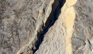 View looking north at the Ice River Spring. Located in the polar desert of northern Ellesmere Island, Nunavut, this spring carves a gully remarkable similar to those observed on Mars. Image credit: Stephen Grasby.