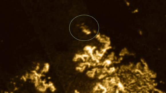 This image shows a bright geologic object, named the Magic Island (green circle) in Ligeia Mare, Titan. Image credit: J.D. Hofgartner et al.