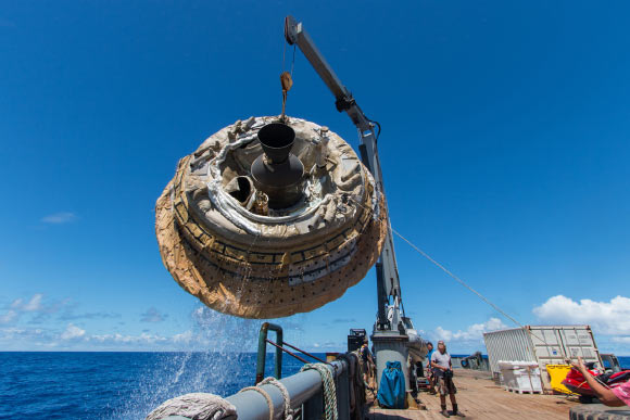 Hours after the June 28, 2014, test of NASA's Low-Density Supersonic Decelerator over the U.S. Navy's Pacific Missile Range, the saucer-shaped test vehicle is lifted aboard the Kahana recovery vessel. Image credit: NASA / JPL-Caltech.