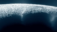 This view looks across the geyser basin of Enceladus, along fractures spewing water vapor and ice particles into space. Image credit: NASA / JPL-Caltech / Space Science Institute.