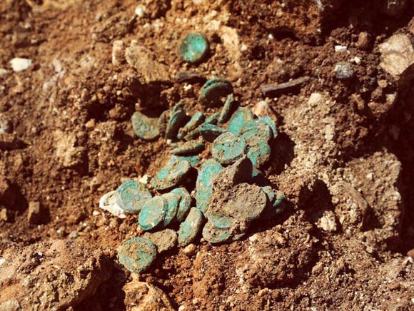 The hoard of 114 bronze coins from the Great Revolt Era unearthed on the outskirts of Jerusalem, Israel. Image credit: Vladimir Niihin / Israel Antiquities Authority.