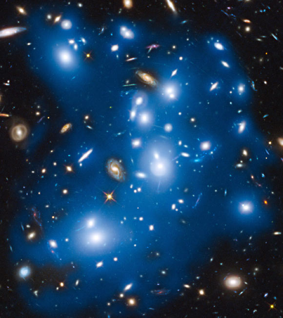 The galaxy cluster Abell 2744 takes on a ghostly look where total starlight has been artificially colored blue in this Hubble view. Image credit: NASA / ESA / IAC / HFF Team / STScI.