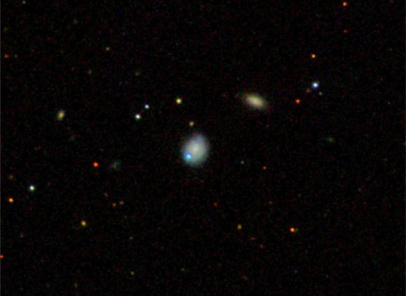 The dwarf galaxy Markarian 177 (center) and SDSS1133 (blue) lie 90 million light-years away. Image credit: Sloan Digital Sky Survey.
