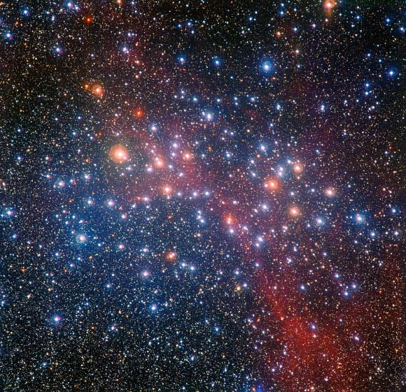 This image of the bright star cluster NGC 3532 was captured by the Wide Field Imager instrument at La Silla Observatory in 2013; some of the stars still shine with a hot bluish color, but many of the more massive ones have become red giants and glow with a rich orange hue. Image credit: ESO / G. Beccari.