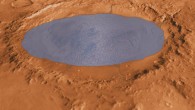 Gale crater is 155 km in diameter and now holds a layered mountain rising about 5 km above the crater floor. This illustration depicts a lake of water partially filling the crater. Image credit: NASA / JPL-Caltech / ASU / UA / Sci-News.com.