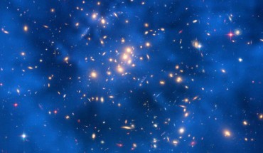 This Hubble composite image shows a ring of dark matter in the galaxy cluster ZwCl0024+1652; the ring-like structure is evident in the blue map of the cluster's dark matter distribution; the map is superimposed on a Hubble image of the cluster. Image credit: NASA / ESA / M.J. Jee and H. Ford, Johns Hopkins University.
