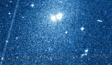 This image shows the newly discovered dwarf galaxy Kks3. The core of the galaxy is the right hand object at the top center of the image, with its stars spreading out over a large section around it; the left hand of the two objects is a much nearer globular star cluster. Image credit: Dimitry Makarov.
