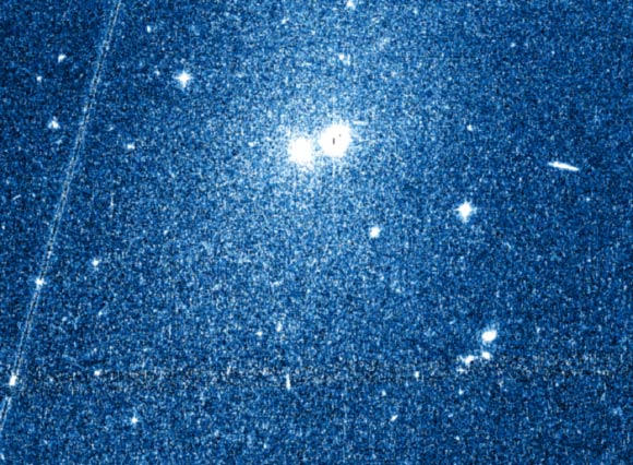 This image shows the newly discovered dwarf galaxy Kks3. The core of the galaxy is the right hand object at the top center of the image, with its stars spreading out over a large section around it; the left hand of the two objects is a much nearer globular star cluster. Image credit: Dimitry Makarov.