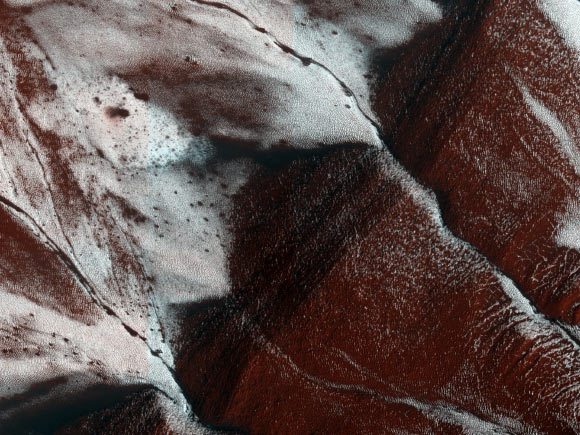This image of an area on the surface of Mars, about 1.5 x 3 km in size, was taken by the HiRISE camera aboard the Mars Reconnaissance Orbiter on November 30, 2014. It shows frosted gullies on a south-facing slope within a crater in Sisyphi Planum. In the Martian southern spring, only south-facing slopes retain the frost, while the north-facing slopes have melted. Image credit: NASA / JPL-Caltech / University of Arizona.