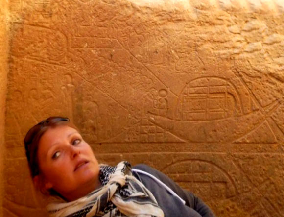 Dr Maria Nilsson near the depiction of Egyptian boats with sandstone blocks. Image credit: Gebel el Silsila Survey Project.