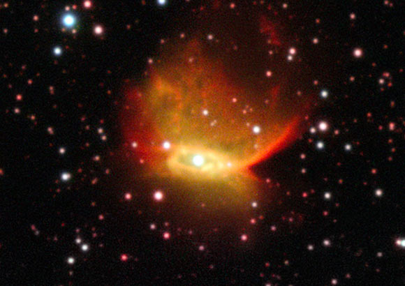 This image of Henize 2-428 was obtained using the Very Large Telescope at the Paranal Observatory in Chile; in the heart of this colorful nebula lies a unique object consisting of two white dwarf stars, each with a mass a little less than that of the Sun; these stars are expected to slowly draw closer to each other and merge in around 700 million years. Image credit: ESO.