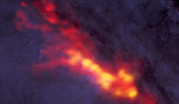 New ALMA data reveal a diffuse envelope of carbon monoxide gas (shown in red), which surrounds regions of active star formation (yellow); by dissecting these regions with this powerful radio telescope, astronomers are uncovering clues to the processes and conditions that drive furious star formation; the ALMA data are superimposed on a Hubble image. Image credit: B. Saxton / NRAO / AUI / NSF / ALMA / ESO / NAOJ / A. Leroy / STScI / NASA / ST-ECF / ESA / CADC / NRC / CSA.