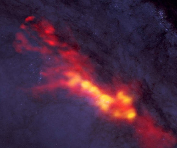 New ALMA data reveal a diffuse envelope of carbon monoxide gas (shown in red), which surrounds regions of active star formation (yellow); by dissecting these regions with this powerful radio telescope, astronomers are uncovering clues to the processes and conditions that drive furious star formation; the ALMA data are superimposed on a Hubble image. Image credit: B. Saxton / NRAO / AUI / NSF / ALMA / ESO / NAOJ / A. Leroy / STScI / NASA / ST-ECF / ESA / CADC / NRC / CSA.