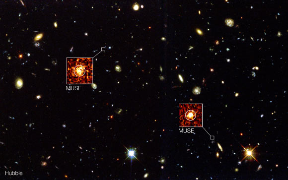 The background image in this composite shows the Hubble image of the region known as the Hubble Deep Field South. New observations using VLT’s MUSE instrument have detected remote galaxies that are not visible to Hubble; two examples are highlighted in this composite view; these objects are completely invisible in the Hubble picture but show up strongly in the appropriate parts of the three-dimensional MUSE data. Image credit: ESO / MUSE Consortium / R. Bacon.