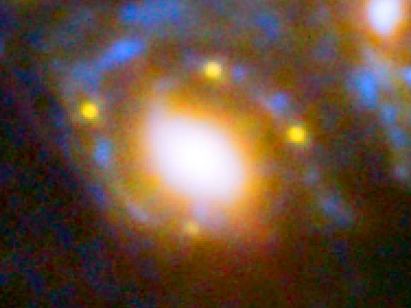 This image shows four different images of SN Refsdal whose light has been distorted and magnified by the massive galaxy cluster MACS J1149+2223 in front of it. The huge mass of the cluster and one of the galaxies within it is bending the light from a supernova behind them and creating four separate images of the supernova. The light has been magnified and distorted due to gravitational lensing and as a result the images are arranged around the elliptical galaxy in a formation known as an Einstein cross. Image credit: NASA / ESA / S. Rodney, JHU / FrontierSN team / T. Treu, UCLA / P. Kelly, UC Berkeley / GLASS team / J. Lotz, STScI / Frontier Fields team / M. Postman, STScI / CLASH team / Z. Levay, STScI.