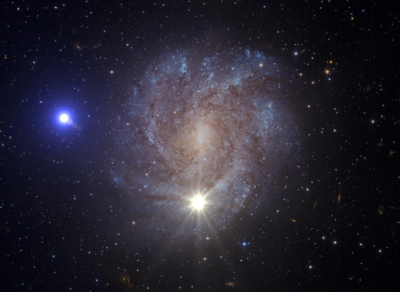 An artist impression of the mass-transfer phase followed by a double-detonation supernova that leads to the ejection of US 708. While this illustration shows the supernova, bottom center, and the ejected star, left, at the same time, in reality the supernova would have been faded away long before the star reached that position. Image credit: ESA / Hubble / NASA / S. Geier.