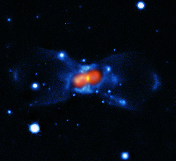 This image shows the remnant of CK Vulpeculae; the image was created from a combination of visible-light images from the Gemini telescope, blue, a submillimeter map showing the dust from the SMA, green, and finally a map of the molecular emission from APEX and the SMA, red. Image credit: ESO / T. Kamiński.