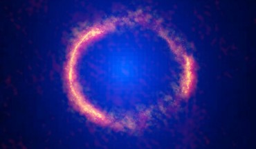 This composite image shows the gravitationally lensed galaxy SDP.81; the bright orange central region of the ring reveals the glowing dust in this distant galaxy; the surrounding lower-resolution portions of the ring trace the millimeter wavelength light emitted by carbon monoxide; the diffuse blue element at the center of the ring is from the intervening lensing galaxy. Image credit: ALMA / NRAO / ESO / NAOJ / B. Saxton / AUI / NSF / NASA / ESA / Hubble / T. Hunter.