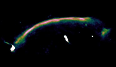 A radio image highlighting the shock wave - seen here as the bright arc running from bottom left to top right - in the cluster CIZA J2242.8+5310. The shock wave was generated 1 billion years ago, when the two original clusters collided, and is moving at a very high speed of 9 million km per hour. Scale bar – 1 million light-years. Image credit: Andra Stroe.