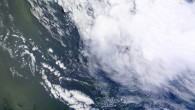 An ocean eddy (bottom of the image) as seen from space. Image credit: NASA Earth Observatory.
