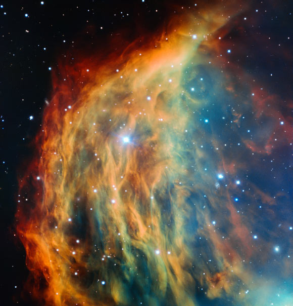 This image uses data from the FORS instrument on the Very Large Telescope. The stellar core of the Medusa Nebula is not the bright star in the center of this image - this is a foreground star called TYC 776-1339-1. Medusa’s central star is a dimmer, bluish star lying just off-center of the crescent shape and in the right-hand part of this image. Image credit: ESO.