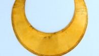 A gold lunula and two small gold discs dating to the Early Bronze Age (2300-1800 BC). Image credit: National Museum of Ireland.
