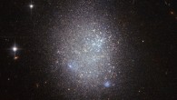 This image shows the irregular blue compact dwarf galaxy UGC 11411 (center). The bright stars are foreground stars in our Milky Way Galaxy. Image credit: ESA / Hubble / NASA.