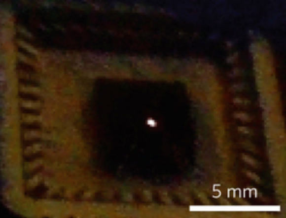 Optical image of remarkably bright visible light emission from suspended mechanically exfoliated few-layer graphene, which is visible even to the naked eye, without additional magnification. Image credit: Young Duck Kim et al.