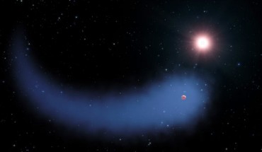 This artist’s concept shows the huge cloud of hydrogen bleeding off of the Neptune-sized exoplanet Gliese 436b. Image credit: NASA / ESA / STScI / G. Bacon.
